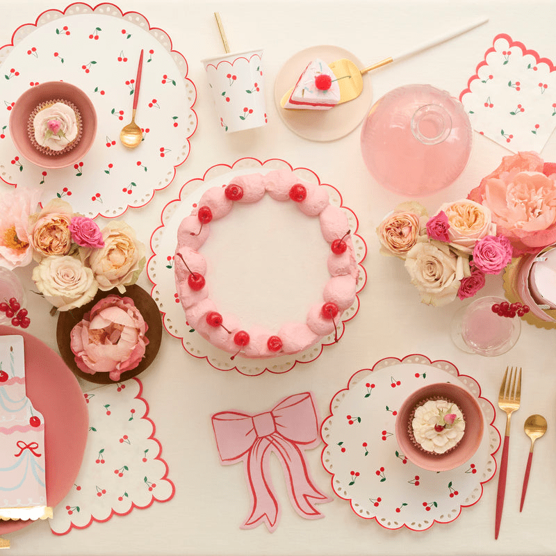 Pink cherry theme tableware with scalloped plates cake and flowers birthday celebration from Parte Haus party supply store in Bethesda Maryland.