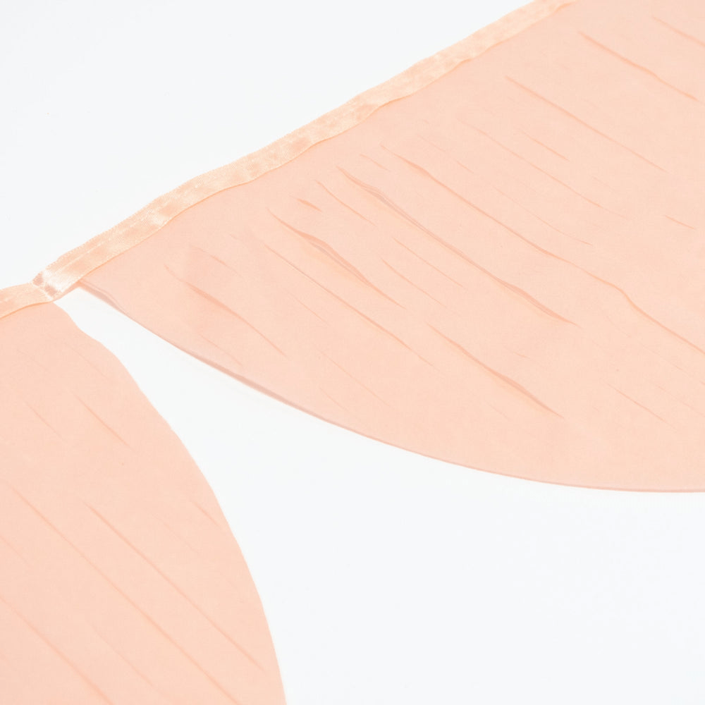 Peach color banner garland with pleated fabric for celebration decor from Parte Haus party supply store in Bethesda MD