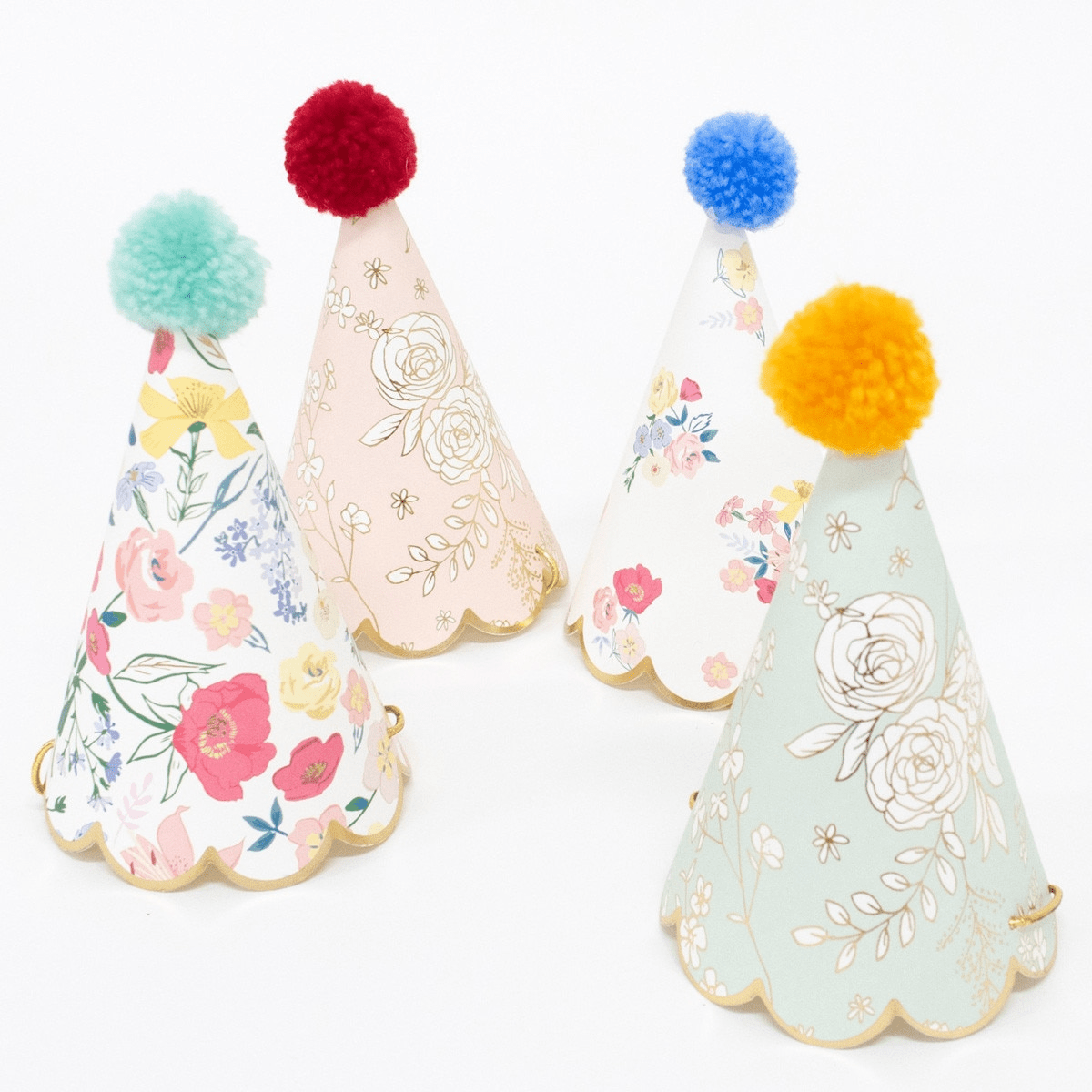 Floral pastel party hats with pom poms birthday theme from Parte Haus party supply store in Bethesda Maryland