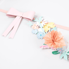 Pink floral garland banner with paper bow for spring celebration from Parte Haus party supply store in Bethesda MD