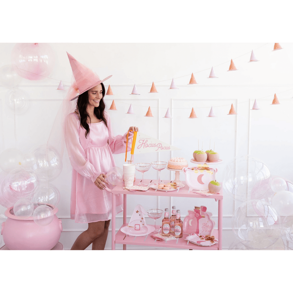 Pink Halloween party table decorations with witch hats and treats Halloween theme from Parte Haus party supply store in Bethesda MD