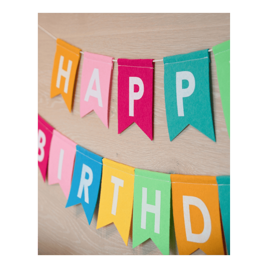 Colorful felt happy birthday banner with white letters birthday decor from Parte Haus party supply store in Bethesda Maryland