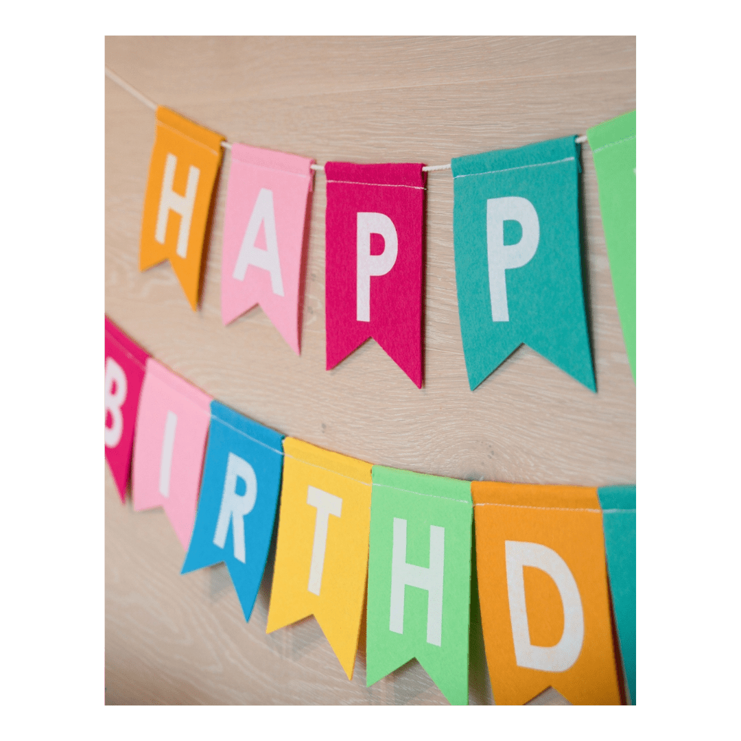 Colorful felt happy birthday banner with white letters birthday decor from Parte Haus party supply store in Bethesda Maryland