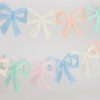 Pastel colored bow garland with cutout design for birthday from Parte Haus party supply store in Bethesda MD
