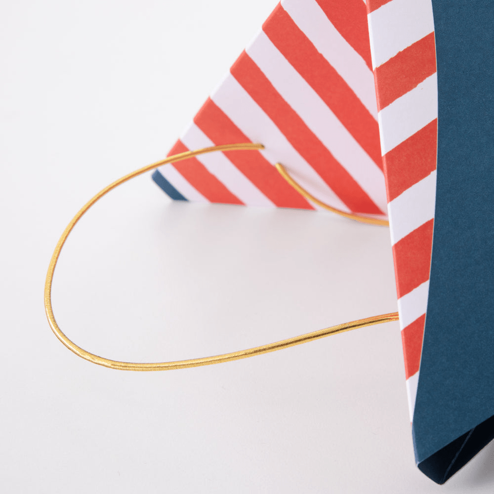 Red and white striped party hat with gold elastic band classic celebration accessory from Parte Haus party supply store in Bethesda Maryland