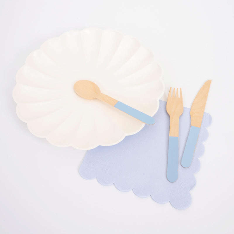 Blue and white tableware set with scalloped plate and wooden cutlery birthday from Parte Haus party supply store in Bethesda Maryland.