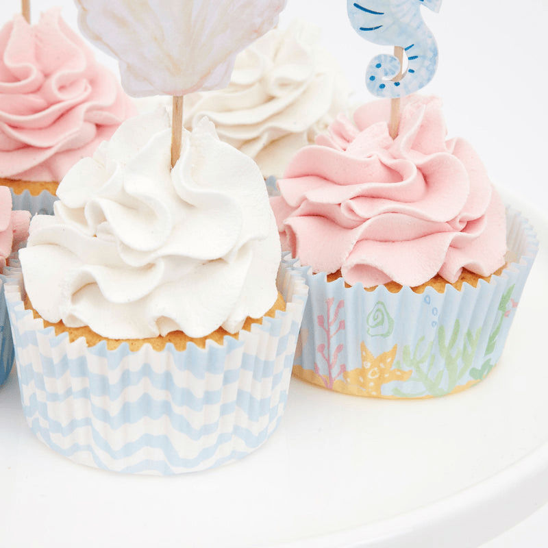 Blue pastel cupcake wrappers with pink and white cupcakes under the sea theme from Parte Haus party supply store in Bethesda MD