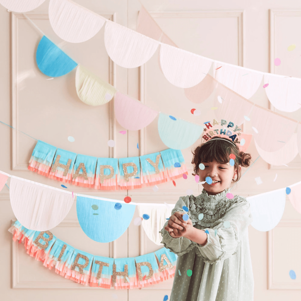 Pastel birthday banner and garlands with confetti and smiling child birthday theme from Parte Haus party supply store in Bethesda MD