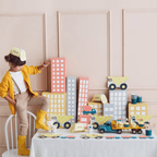 Yellow construction themed birthday party table with toy dump trucks and city decorations from Parte Haus party supply store in Bethesda MD