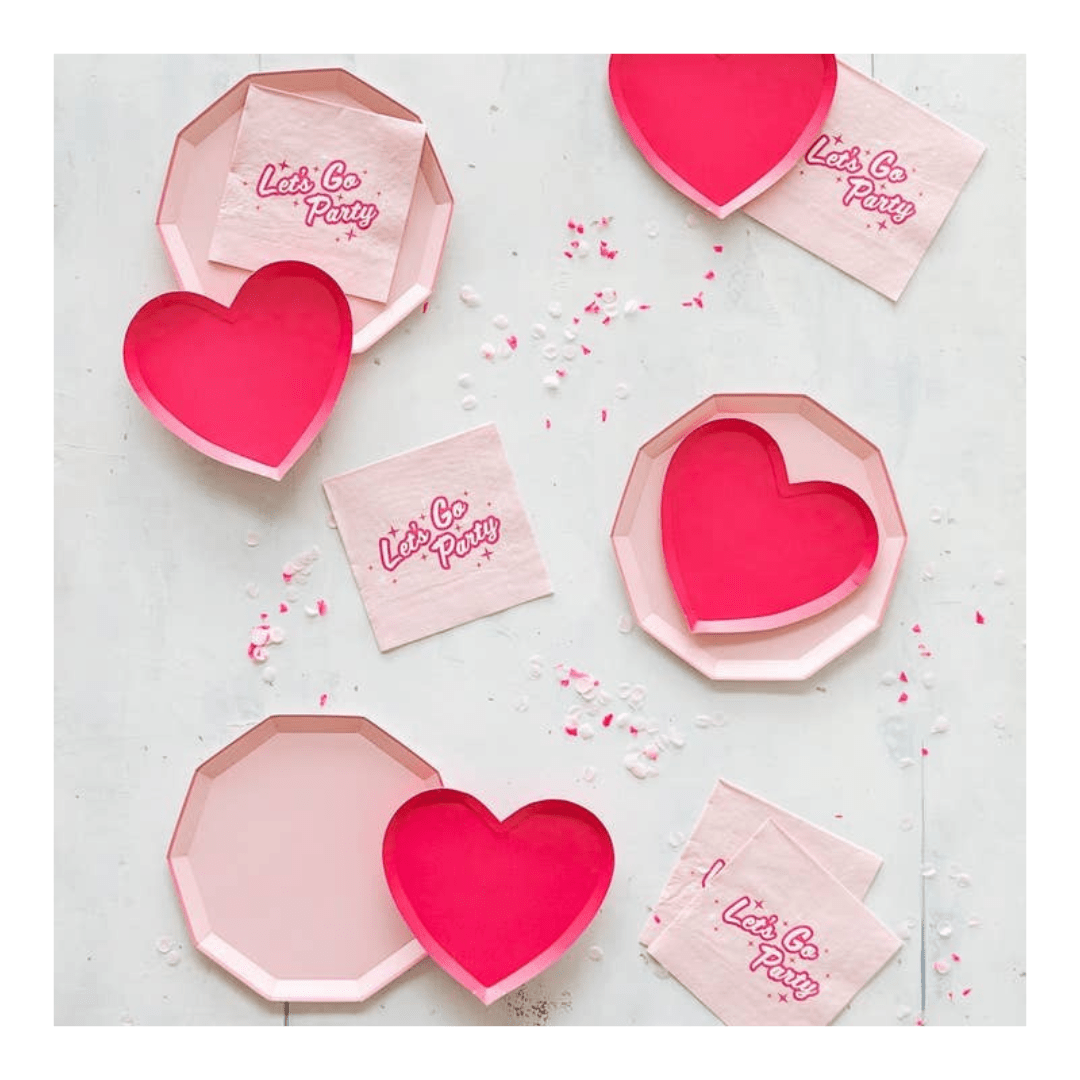 Pink heart plate and napkin set with Lets Go Party text for birthday from Parte Haus party supply store in Bethesda Maryland