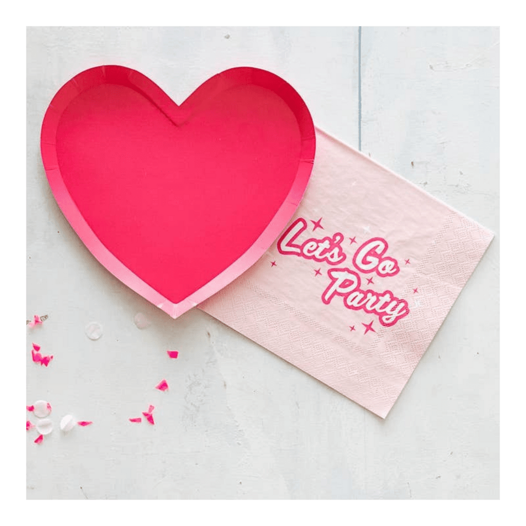 Pink heart plate and Let’s Go Party napkin for celebration theme from Parte Haus party supply store in Bethesda MD