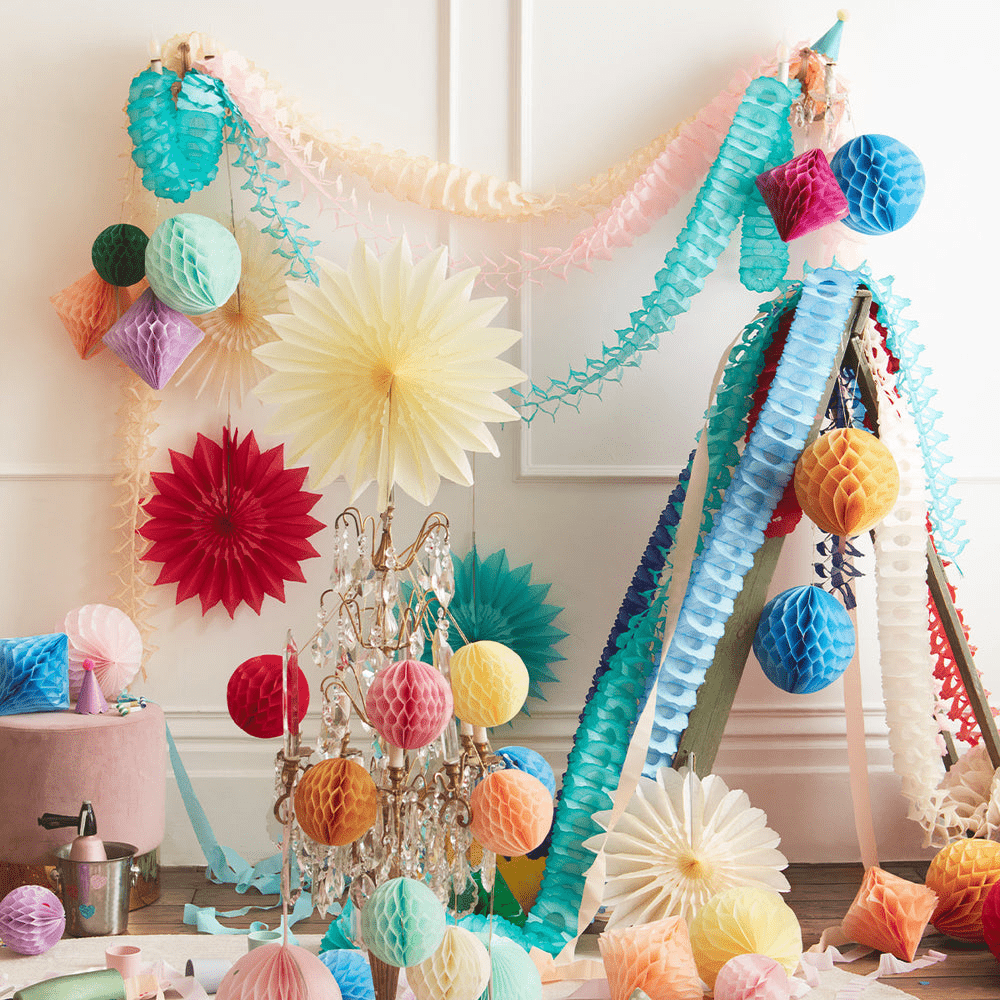 Multicolor paper decorations garland and hanging fans for birthday from Parte Haus party supply store in Bethesda MD