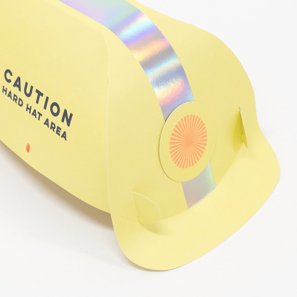 Yellow paper construction hat with holographic stripe birthday theme from Parte Haus party supply store in Bethesda MD.