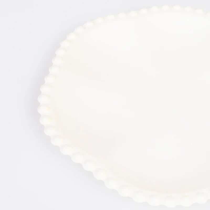 Cream white scalloped plate elegant design for celebrations from Parte Haus party supply store in Bethesda Maryland
