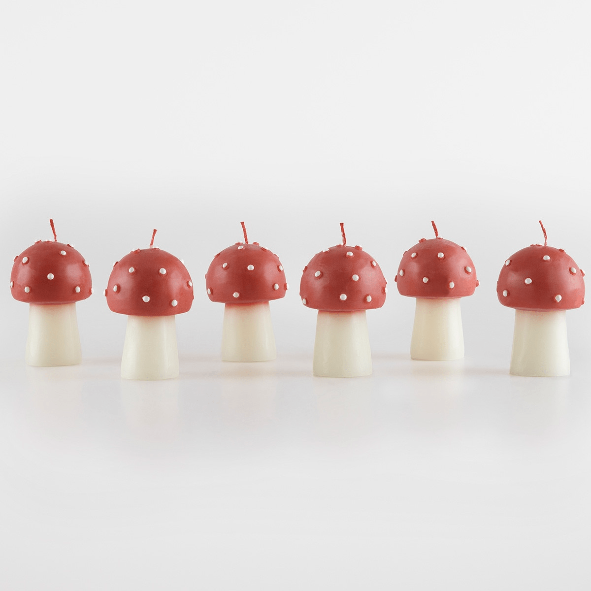 Red mushroom shaped birthday candles whimsical decor from Parte Haus party supply store in Bethesda Maryland.