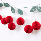 Red cherry garland honeycomb decoration with green leaves fruit theme from Parte Haus party supply store in Bethesda MD