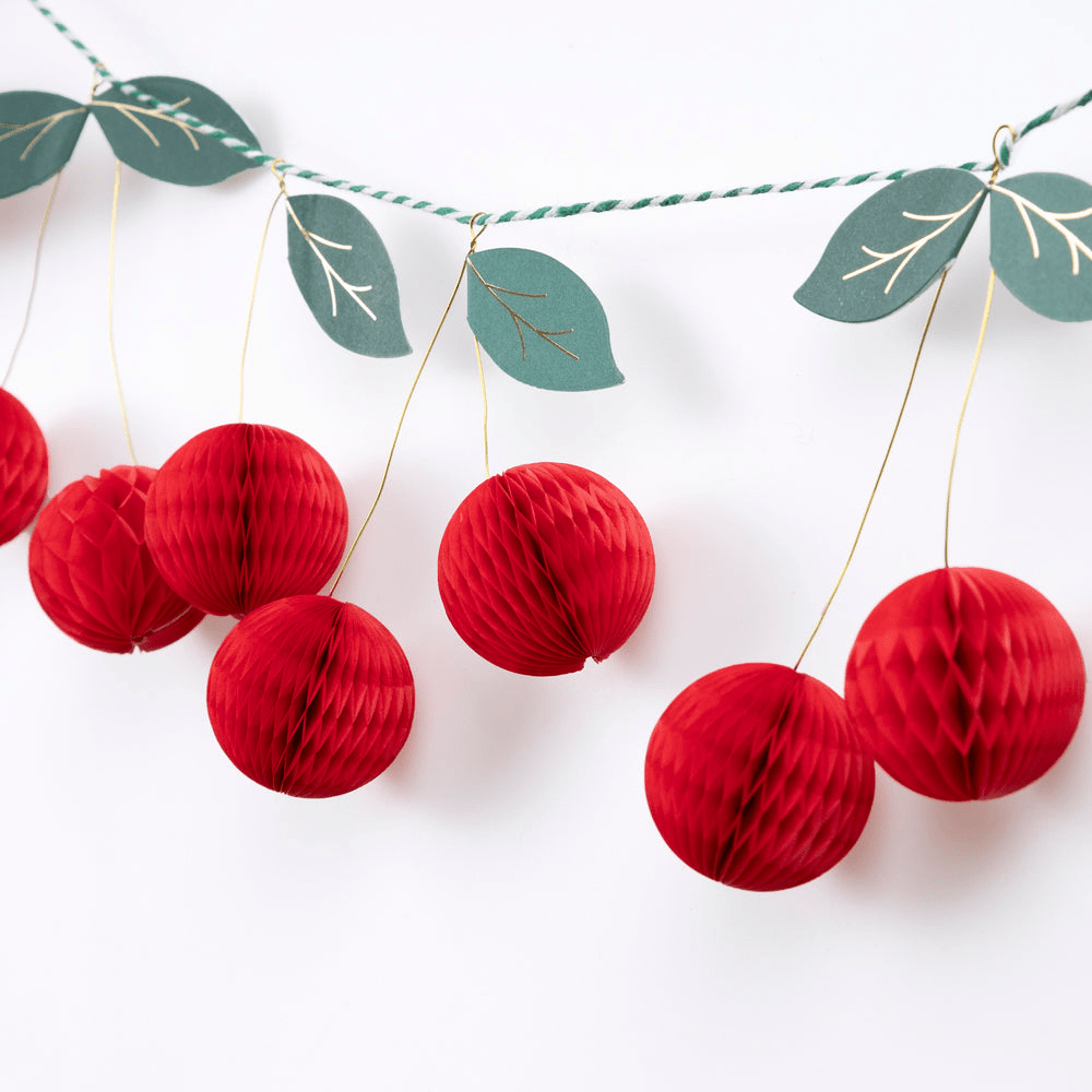 Red cherry garland honeycomb decoration with green leaves fruit theme from Parte Haus party supply store in Bethesda MD
