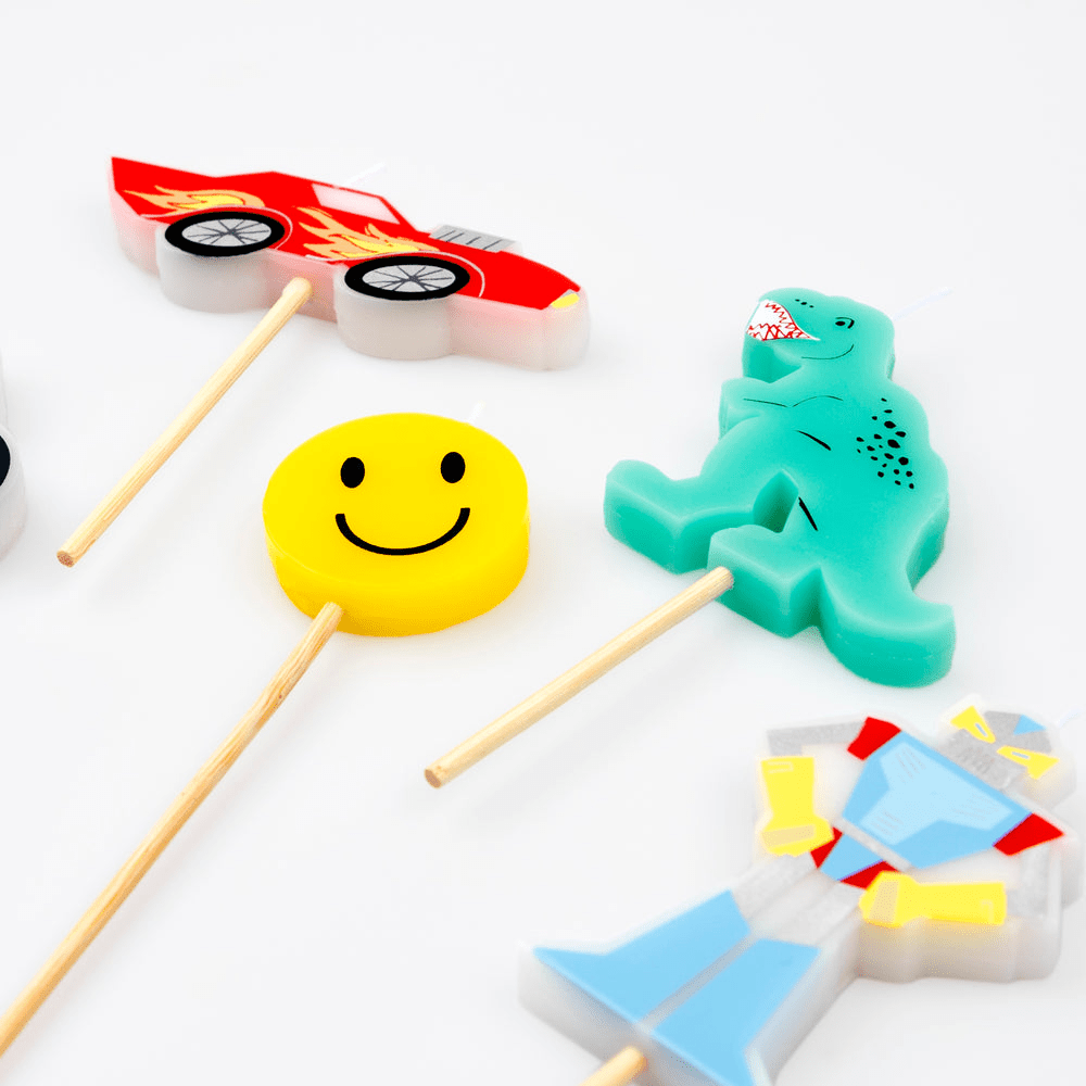 Colorful shaped birthday candles including smiley face dinosaur car and robot from Parte Haus party supply store in Bethesda Maryland