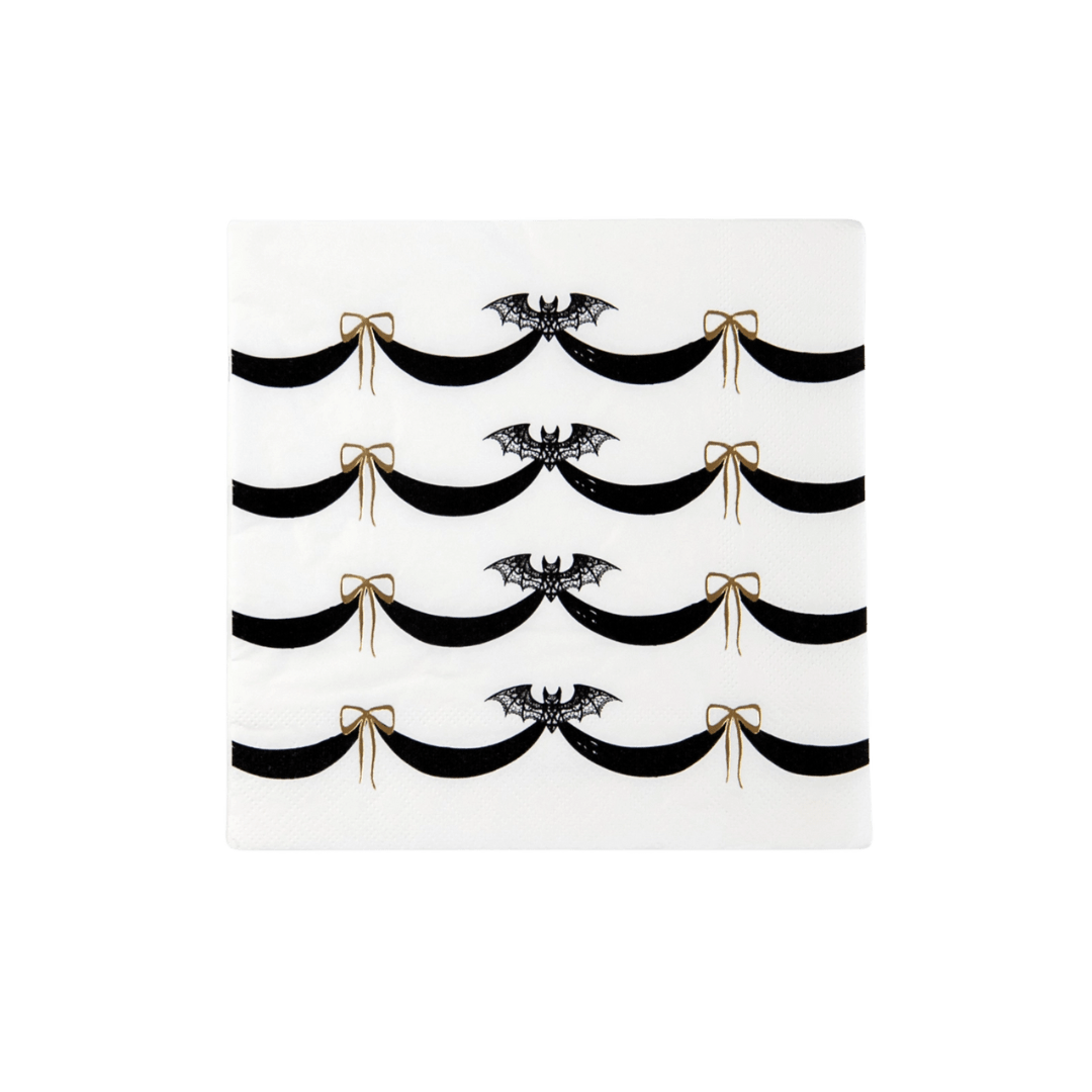 Black and white Halloween napkin with bats and gold bows from Parte Haus party supply store in Bethesda Maryland