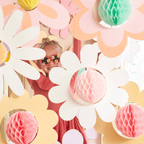 Pastel flower garland decor with pink honeycomb balls for spring birthday theme from Parte Haus party supply store in Bethesda MD.