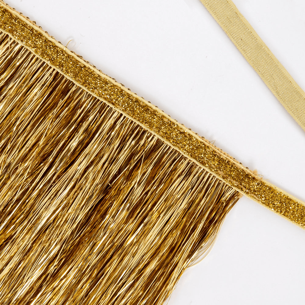 Gold tinsel fringe banner with glitter detail for celebration theme from Parte Haus party supply store in Bethesda MD