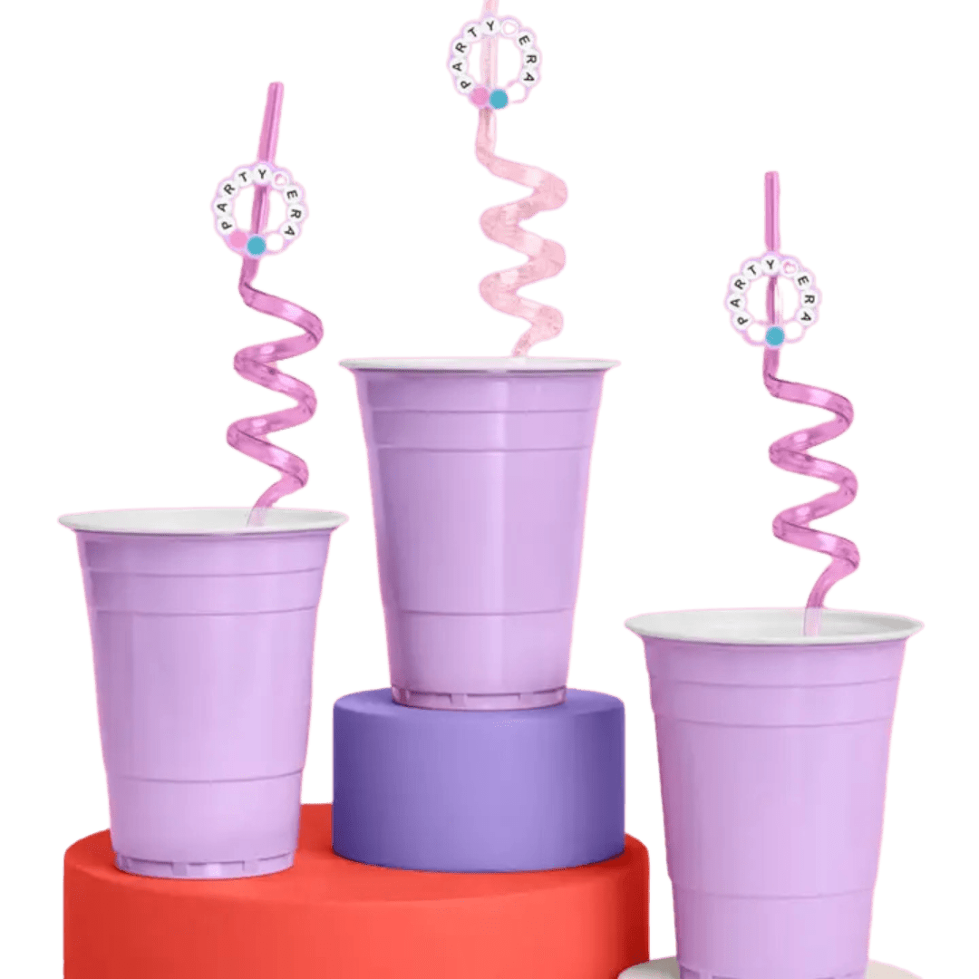 purple plastic cups with pink spiral straws on colorful stands from Parte Haus party supply store in Bethesda MD