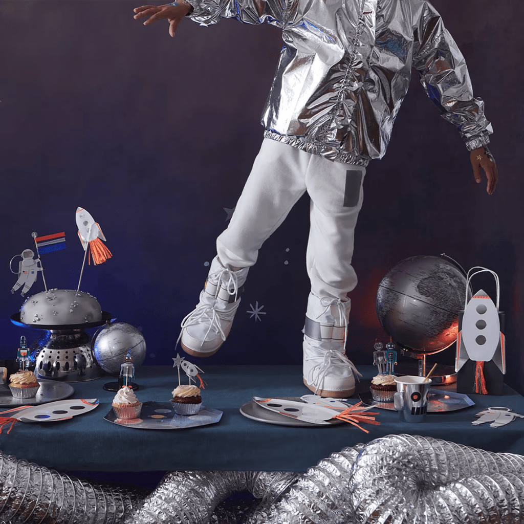 silver and white space themed party decorations cupcakes and astronaut costume for space birthday from Parte Haus party supply store in Bethesda MD