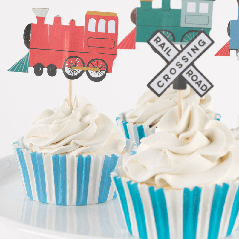 Red and blue train cupcake toppers on striped cupcakes train birthday theme from Parte Haus party supply store in Bethesda Maryland.