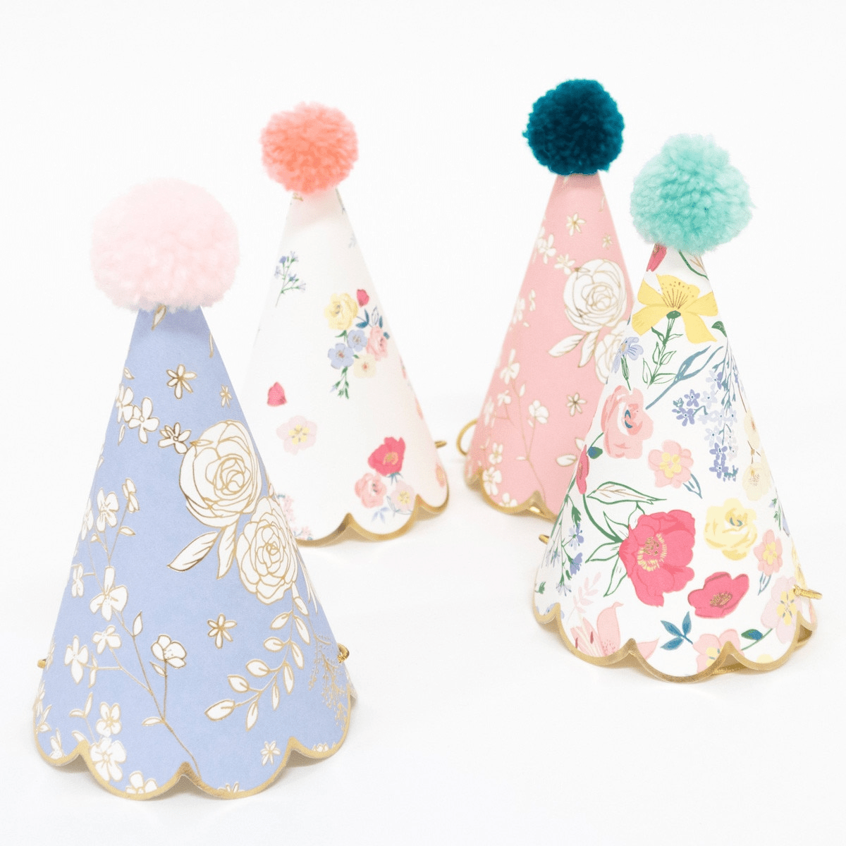 Floral pastel party hats with pom poms birthday theme from Parte Haus party supply store in Bethesda Maryland