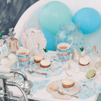 Pastel mermaid birthday table decor with cupcakes and blue balloons from Parte Haus party supply store in Bethesda Maryland