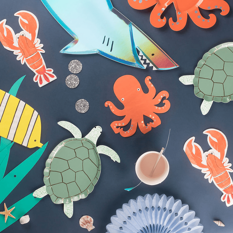 colorful under the sea theme plates and decorations with shark octopus turtle crab fish from Parte Haus party supply store in Bethesda Maryland