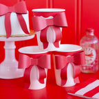 Red and white paper cups with red bow accents for birthday celebration from Parte Haus party supply store in Bethesda MD