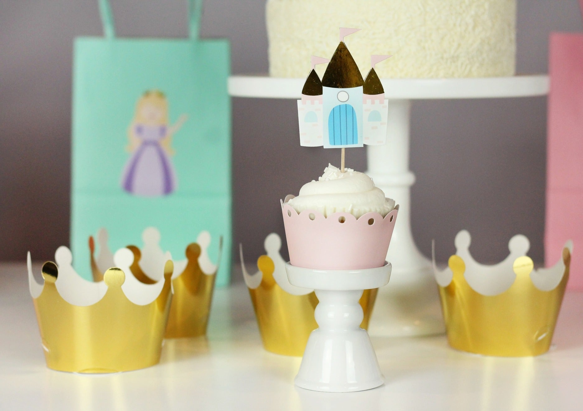 Pink princess cupcake with castle topper gold crown mini tiaras princess birthday from Parte Haus party supply store in Bethesda Maryland