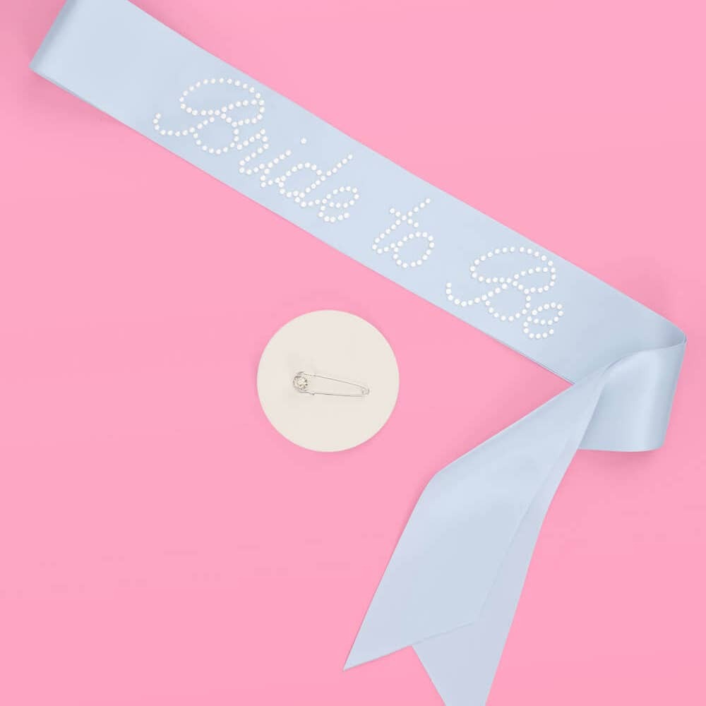 Light blue bride to be sash with rhinestone text for bridal shower from Parte Haus party supply store in Bethesda MD