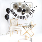 Black and white decoration set with balloons banners chair for celebration theme from Parte Haus party supply store in Bethesda MD