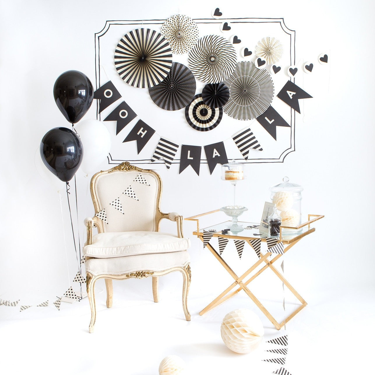 Black and white decoration set with balloons banners chair for celebration theme from Parte Haus party supply store in Bethesda MD