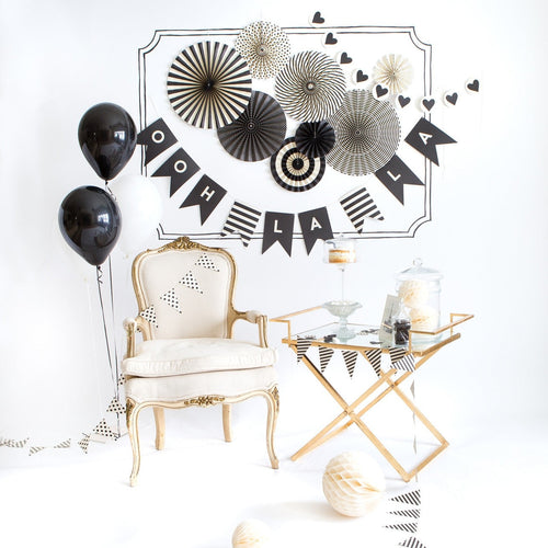 Black and white decoration set with balloons banners chair for celebration theme from Parte Haus party supply store in Bethesda MD