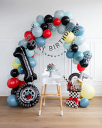 Multicolor race car birthday balloon arch with gifts first birthday theme from Parte Haus party supply store in Bethesda MD