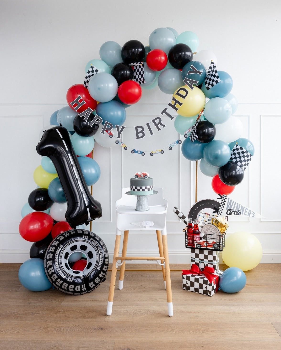 Multicolor race car birthday balloon arch with gifts first birthday theme from Parte Haus party supply store in Bethesda MD