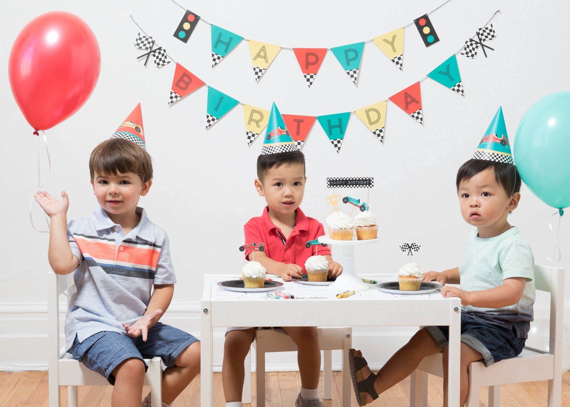Colorful race car birthday hats banner and balloons kids birthday party from Parte Haus party supply store in Bethesda MD