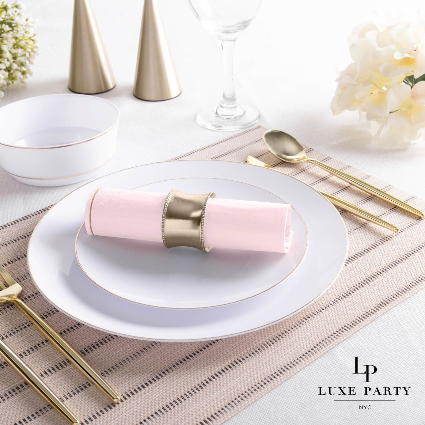 Pink and gold elegant table setting with plates and napkin for birthday from Parte Haus party supply store in Bethesda MD