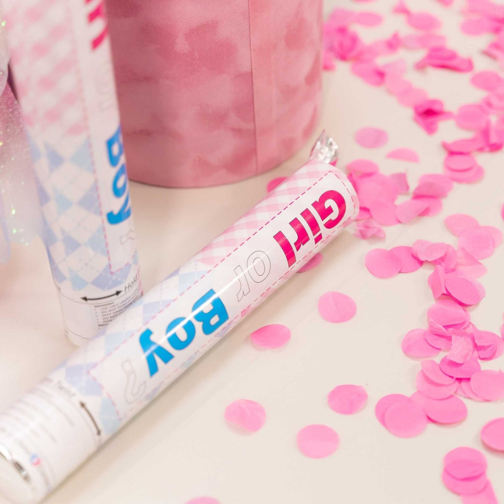 Pink and blue gender reveal confetti poppers with pink confetti from Parte Haus party supply store in Bethesda MD