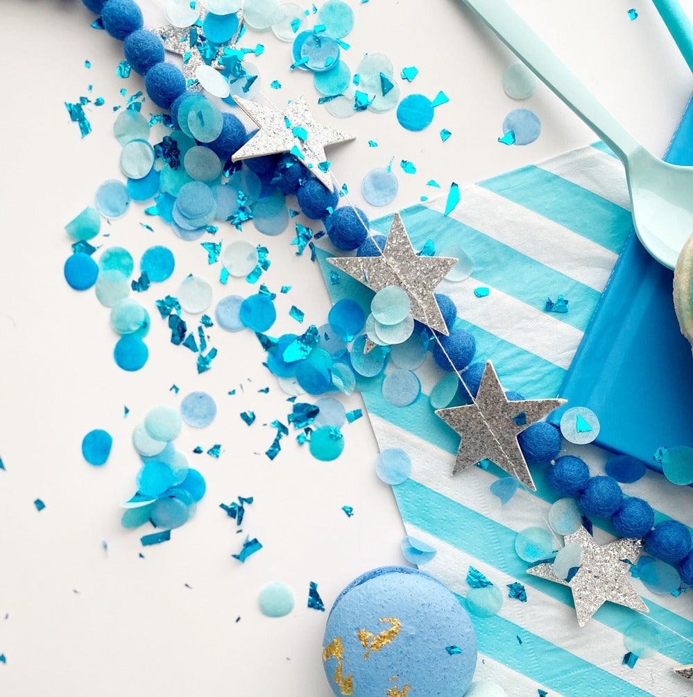 Blue confetti and silver star garland celebration decor for birthday from Parte Haus party supply store in Bethesda MD