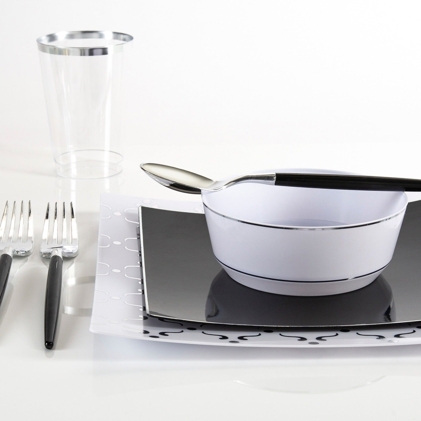 Black and white upscale dinnerware set with forks bowl and spoon modern tableware for formal event from Parte Haus party supply store in Bethesda Maryland