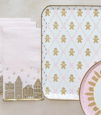 Pink and gold gingerbread plate and napkin set with holiday village design Christmas from Parte Haus party supply store in Bethesda MD