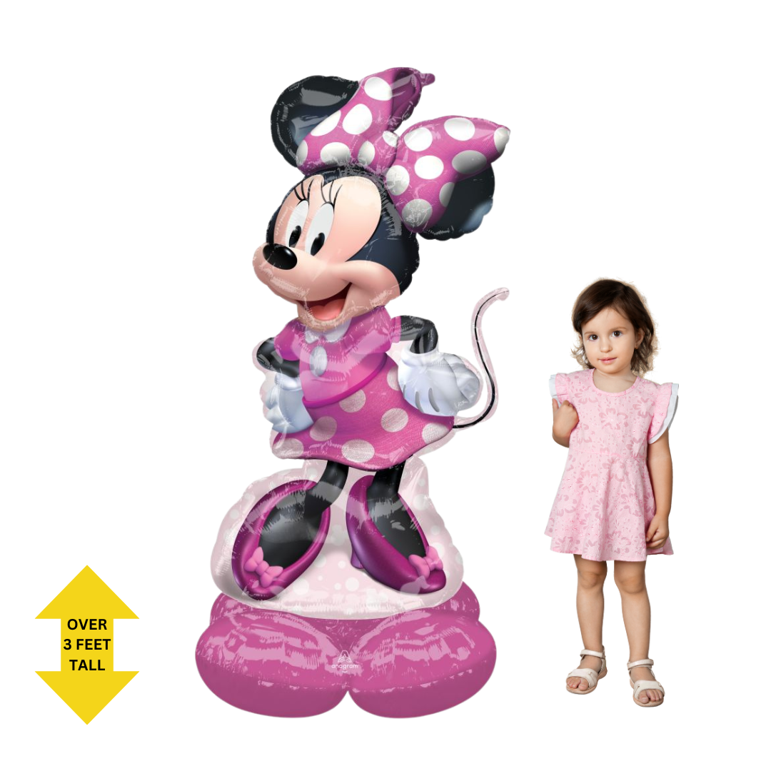 Life-size pink Minnie Mouse 48in foil balloon shown next to child - from Parte Haus party supply store in Bethesda, Maryland.