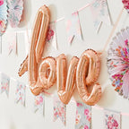 Rose gold love balloon with floral banners for romantic event from Parte Haus party supply store in Bethesda Maryland